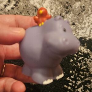 Fisher-Price Little People purple hippopotamus figure featuring a small red bird